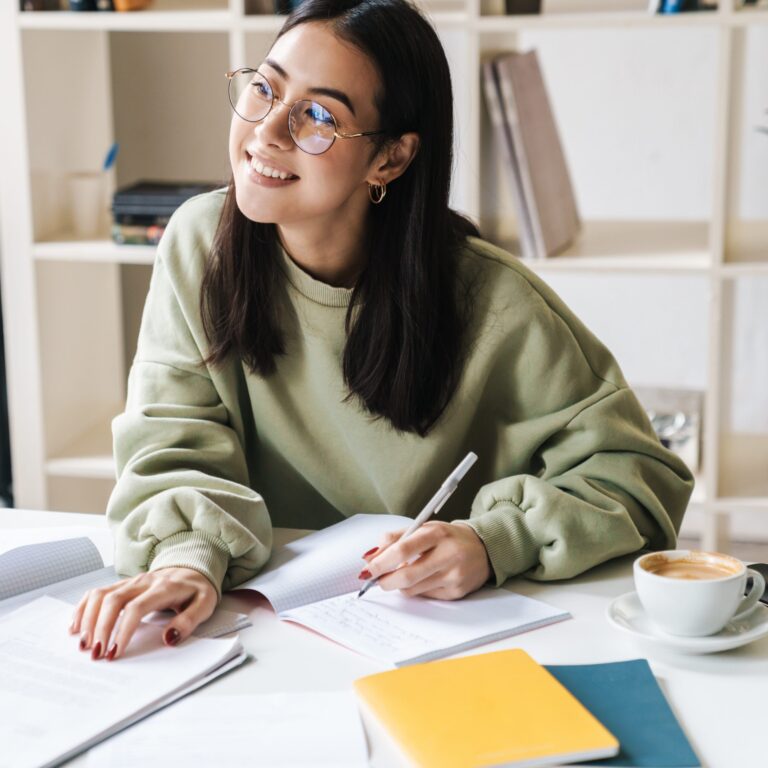Attractive,happy,young,girl,student,studying,at,the,college,library,